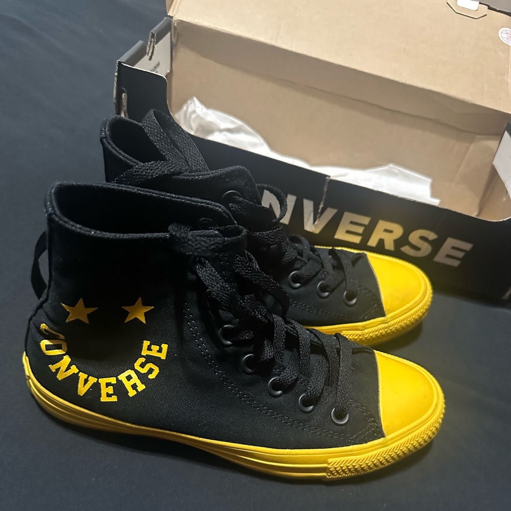Black and yellow smiley converse